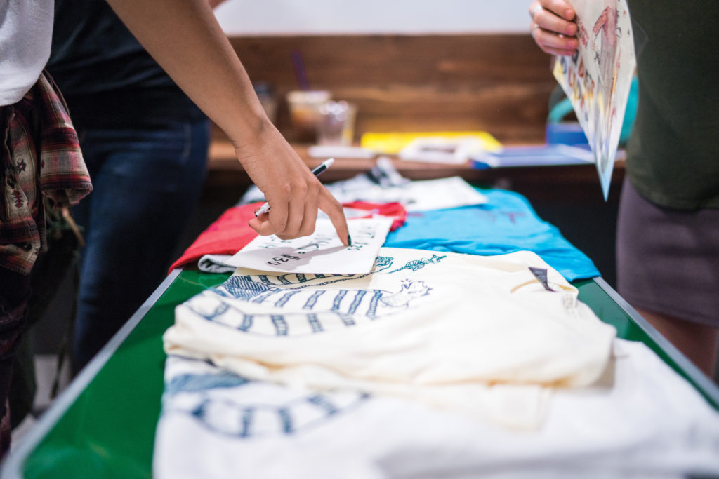 [Daren Stevens | Banner] Geoff Gouveia, California Baptist University alumnus, recently released a T-shirt he designed in partnership with Augie’s Coffee House. The shop held an event featuring live music Sept. 17 in celebration of the unveiling of Gouveia’s T-shirt.